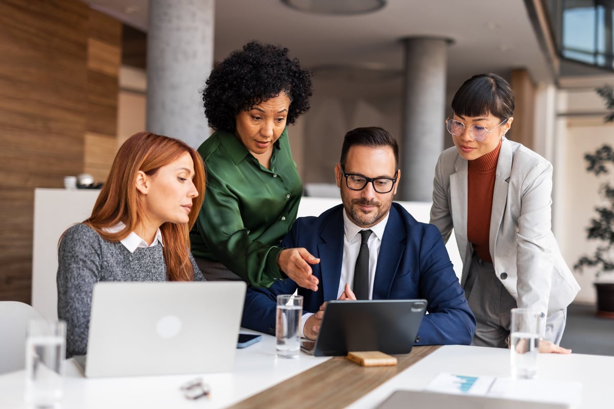 Small business team working together with laptops in their office