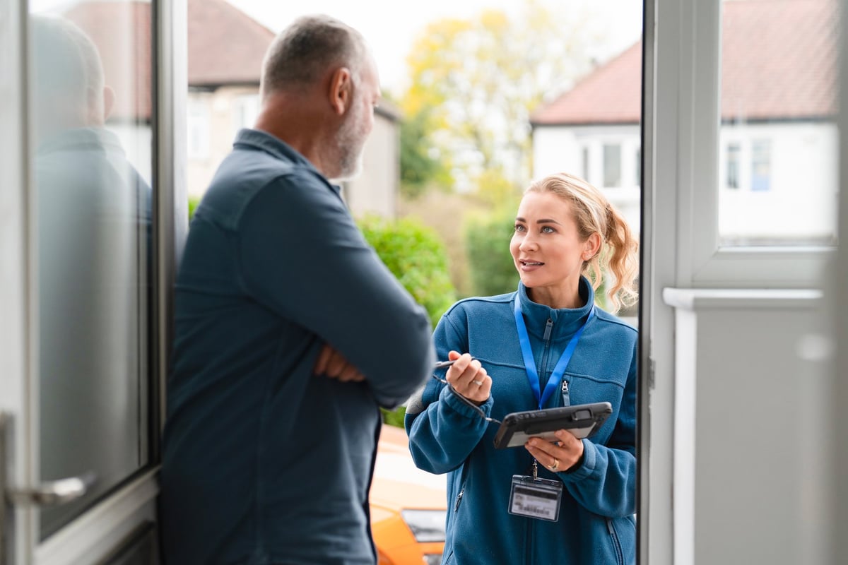 Service technician speaking with a homeowner
